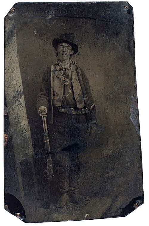 Original: A young man with a rifle, photographed on a tintype around 1880
